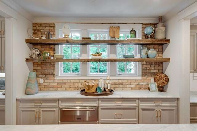 bar featuring a healthy amount of sunlight and light stone countertops