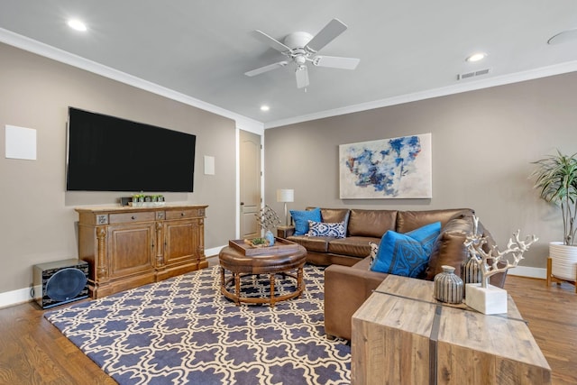 living room featuring ceiling fan, ornamental molding, and hardwood / wood-style floors