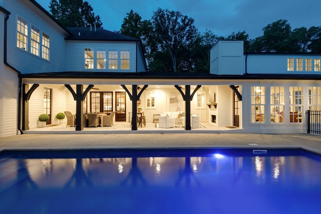 view of pool with an outdoor living space and a patio