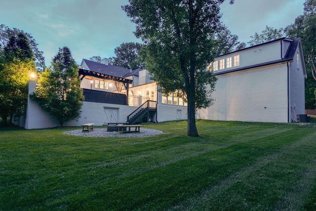 view of yard featuring central AC unit and an outdoor fire pit