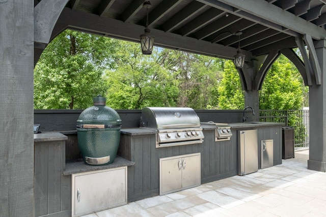 view of patio with exterior kitchen, sink, and grilling area