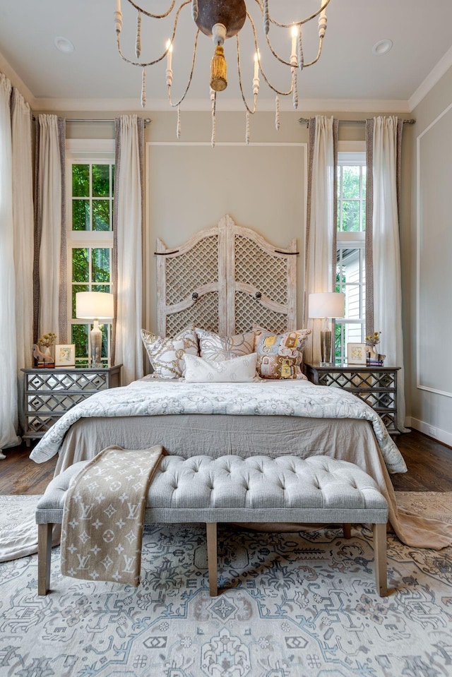 bedroom with crown molding and a chandelier