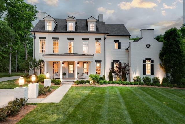 view of front of property featuring a yard and covered porch