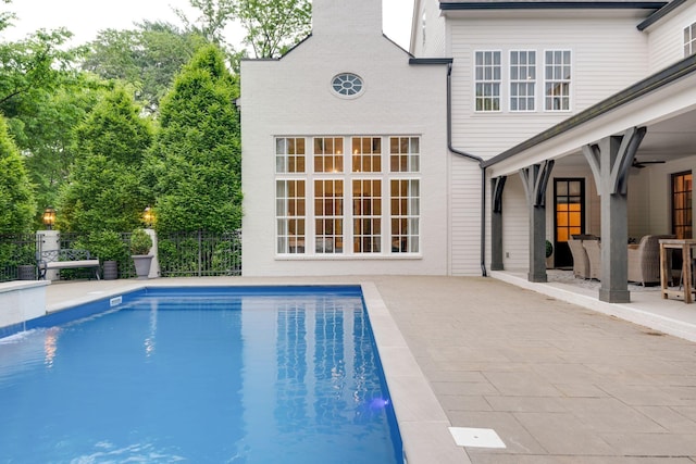 view of swimming pool featuring a patio and ceiling fan