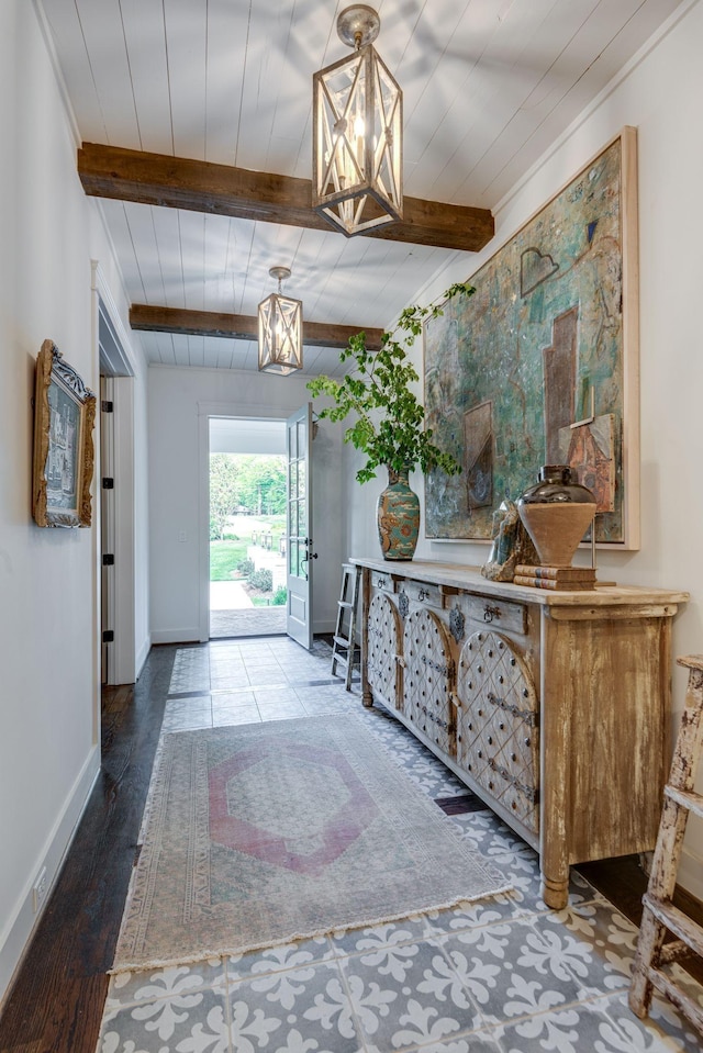 entryway featuring beam ceiling, hardwood / wood-style floors, and a notable chandelier