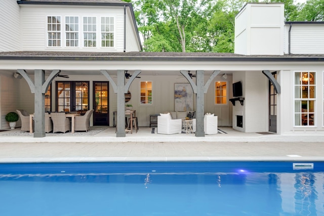 back of house featuring french doors, ceiling fan, an outdoor living space, and a patio