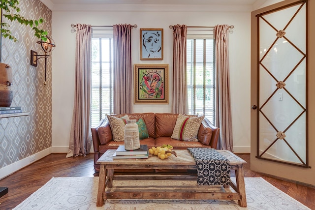 living room with hardwood / wood-style flooring and crown molding