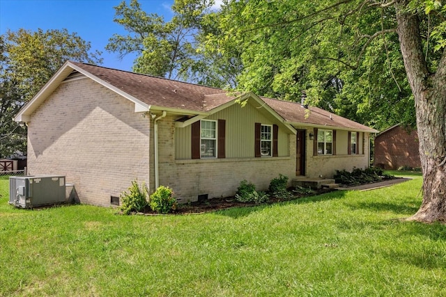 view of front of property with central AC unit and a front yard