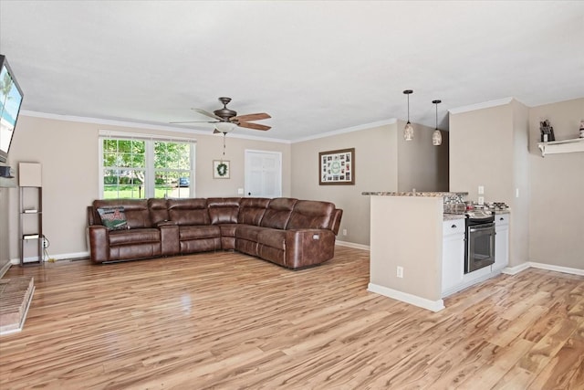 living room featuring crown molding, ceiling fan, and light hardwood / wood-style flooring