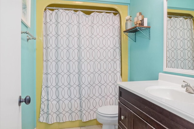 bathroom featuring vanity, toilet, and curtained shower