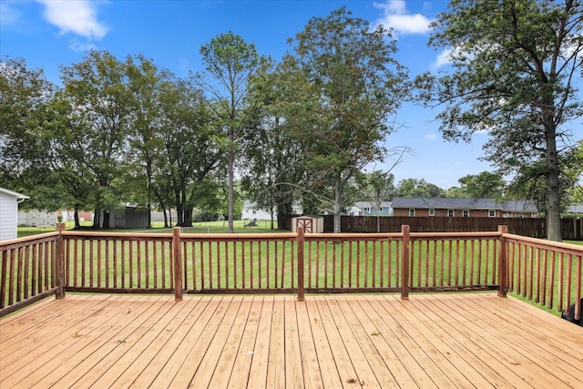 wooden deck with a storage shed and a yard