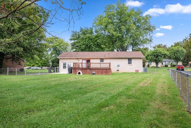 back of house featuring a yard, central AC, and a deck