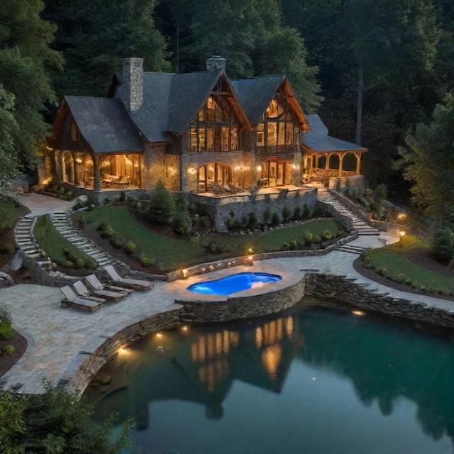 back of property with a swimming pool with hot tub