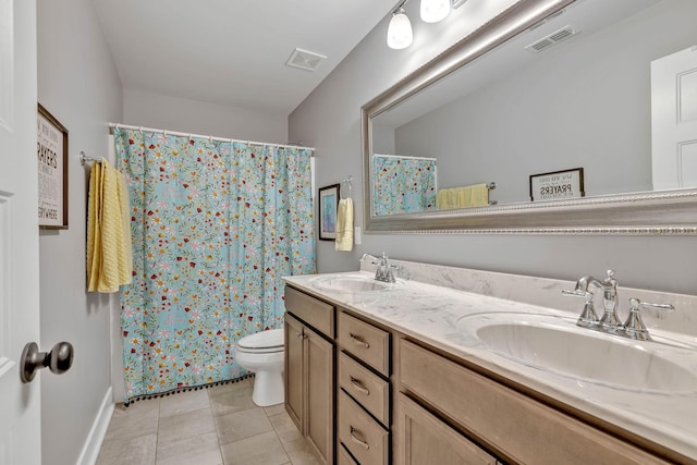 bathroom featuring tile patterned floors, vanity, toilet, and curtained shower