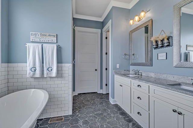 bathroom with crown molding, vanity, a bath, and tile walls