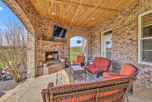 view of patio / terrace with an outdoor living space with a fireplace