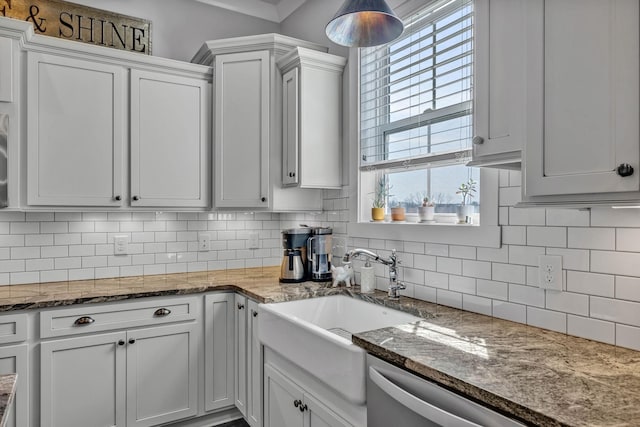 kitchen with backsplash, dark stone counters, and white cabinets