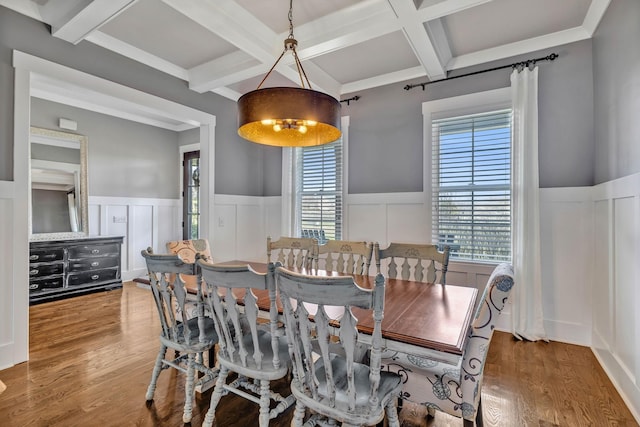 dining space with wood-type flooring, coffered ceiling, and beam ceiling