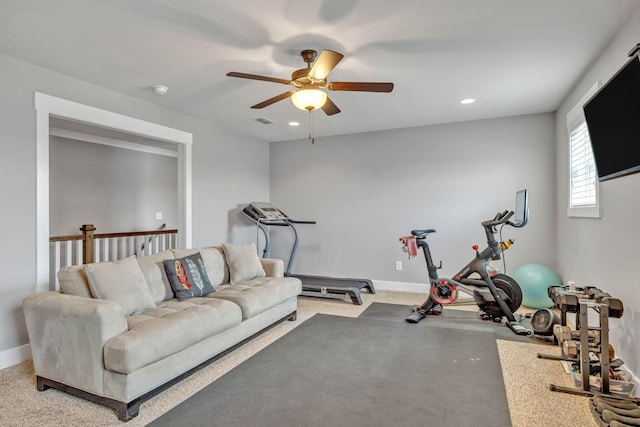 exercise area with ceiling fan and light carpet