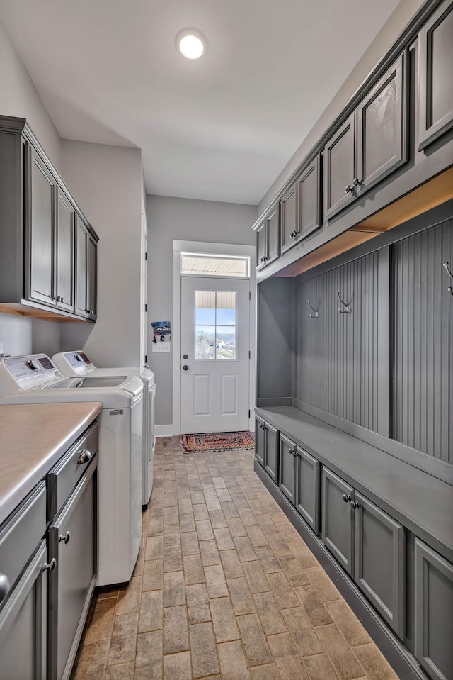 laundry room featuring cabinets and washing machine and dryer