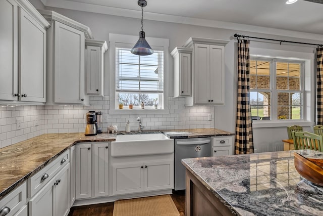 kitchen with sink, dishwasher, backsplash, white cabinets, and decorative light fixtures