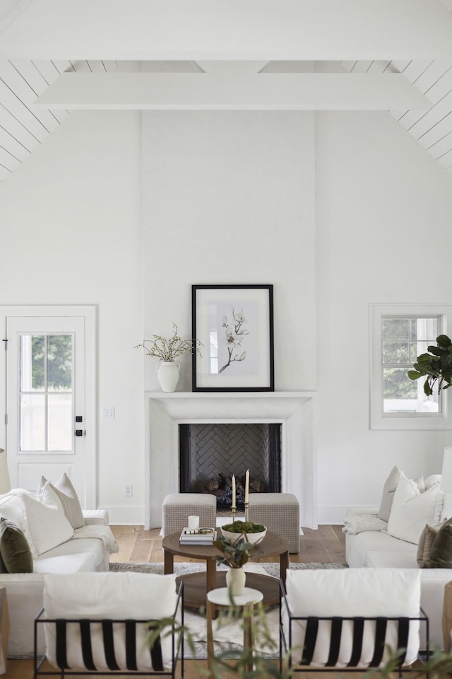 living room featuring wood-type flooring, high vaulted ceiling, and wood ceiling