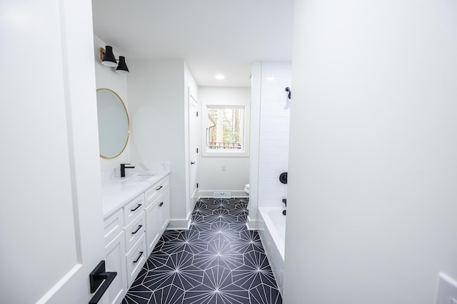 bathroom featuring recessed lighting, baseboards, vanity, and toilet