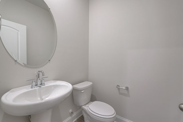 bathroom featuring sink and toilet