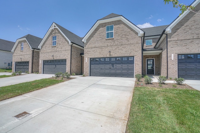 view of front of home featuring a garage and a front lawn