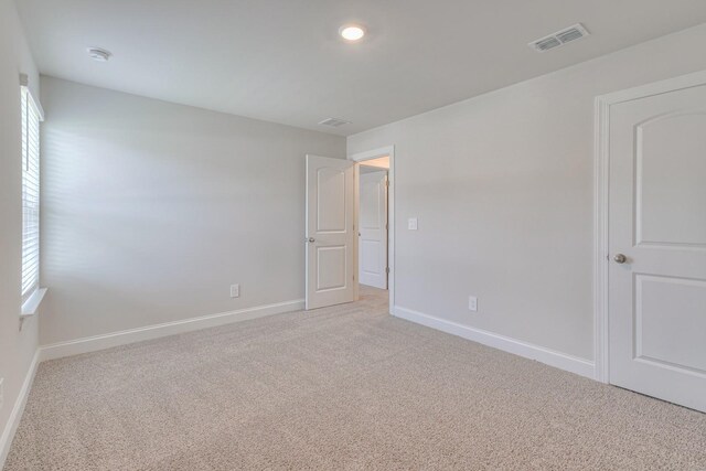 carpeted spare room with a healthy amount of sunlight