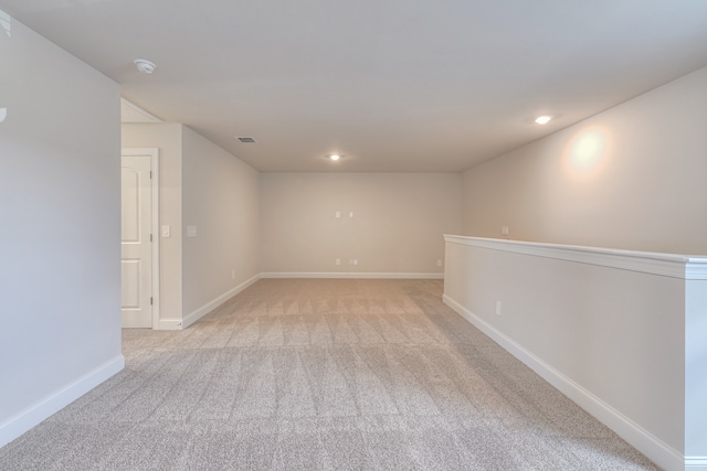 spare room featuring light colored carpet