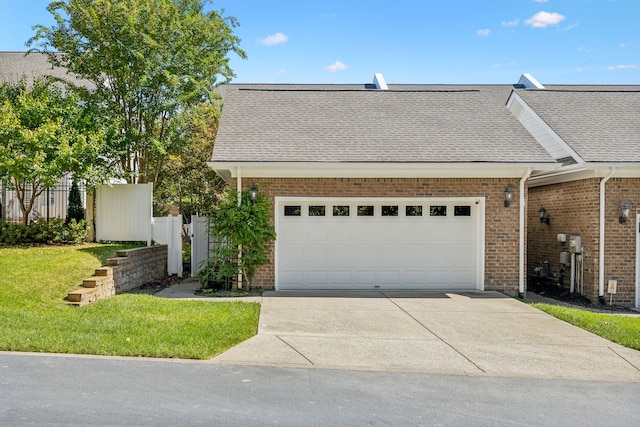 view of front of house with a garage and a front yard