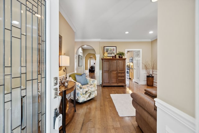 sitting room with hardwood / wood-style flooring and crown molding