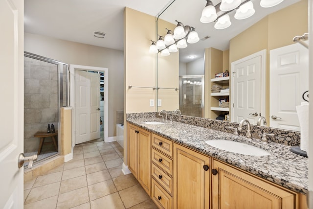 bathroom with tile patterned floors, vanity, and a shower with shower door