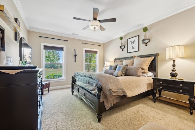 carpeted bedroom with crown molding and ceiling fan