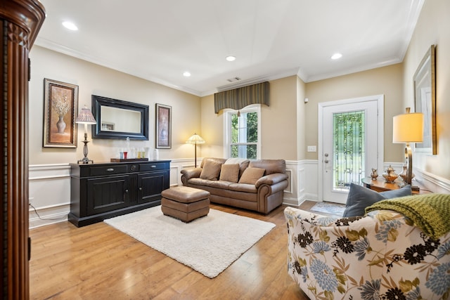 living room featuring ornamental molding and light hardwood / wood-style floors