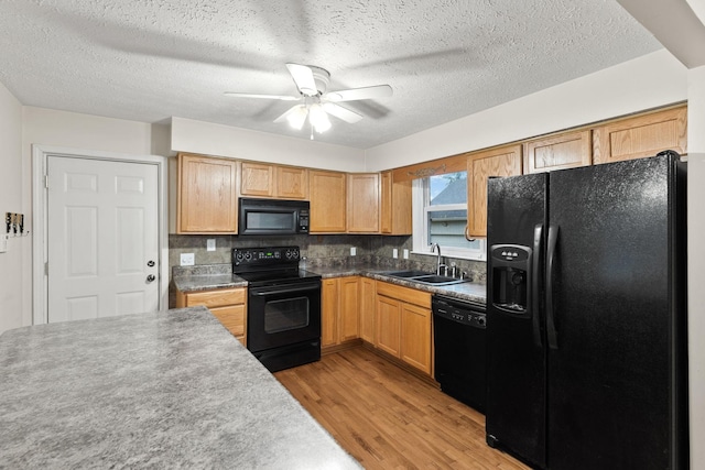 kitchen with sink, tasteful backsplash, ceiling fan, light hardwood / wood-style floors, and black appliances