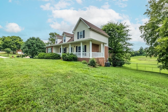 view of home's exterior with a yard, central air condition unit, and a porch