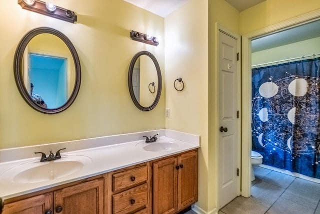 bathroom with vanity, tile patterned floors, and toilet