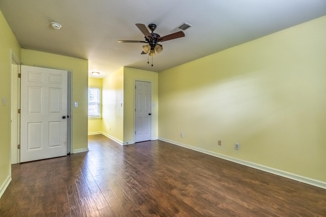 empty room featuring ceiling fan and dark hardwood / wood-style floors