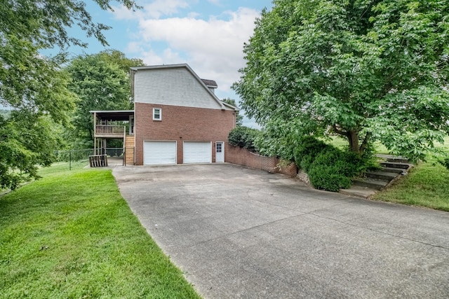 view of home's exterior featuring a garage and a lawn