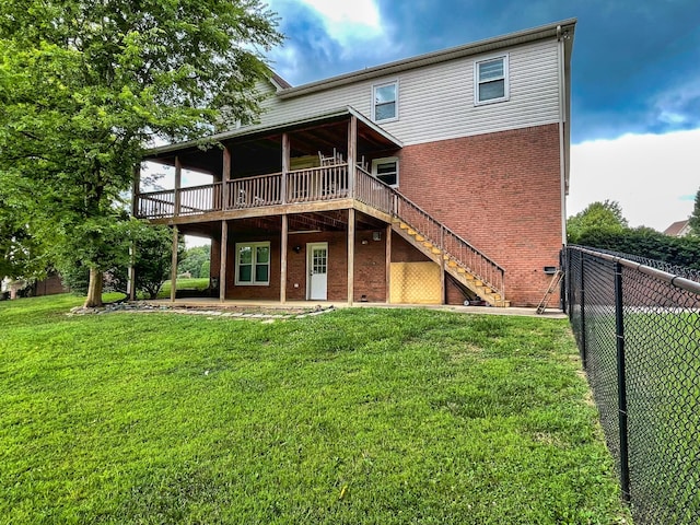 back of house featuring a patio, a deck, and a lawn