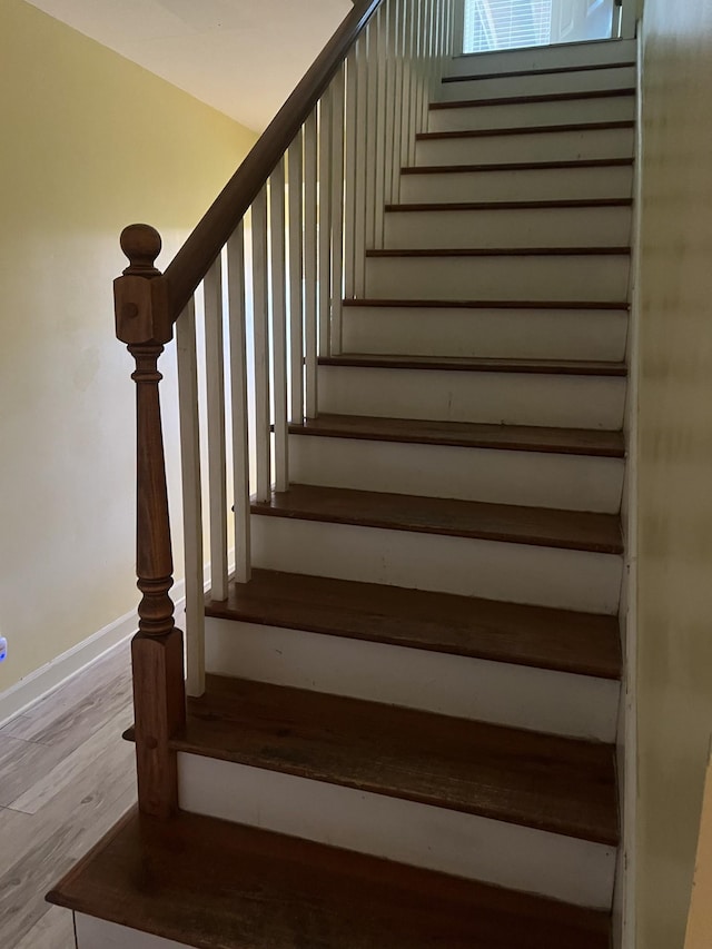 stairs with wood-type flooring