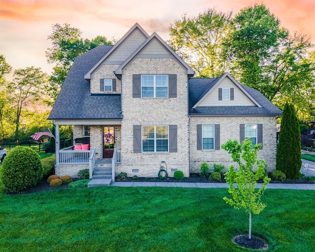 view of front of home featuring a porch and a lawn