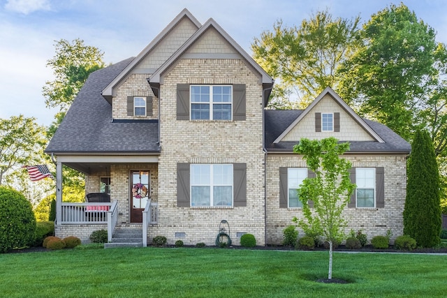 craftsman-style house featuring a porch and a front yard