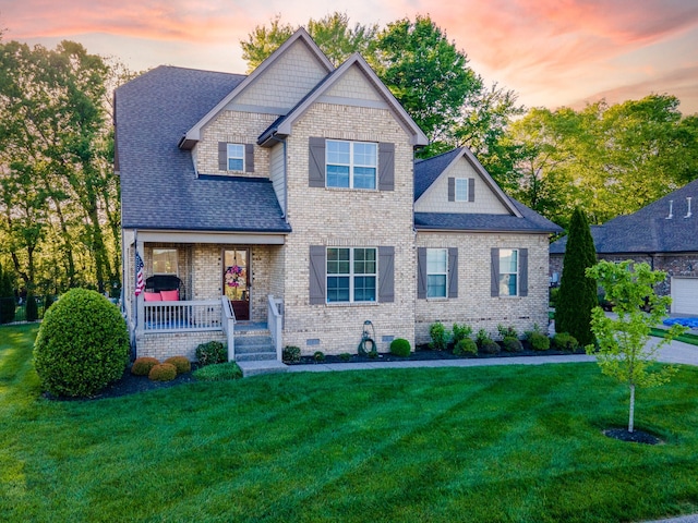 craftsman-style house featuring a yard and covered porch