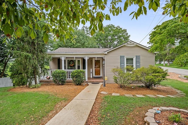 view of front of home featuring covered porch and a front lawn