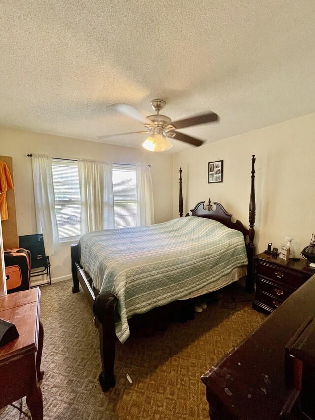 carpeted bedroom featuring a textured ceiling and ceiling fan