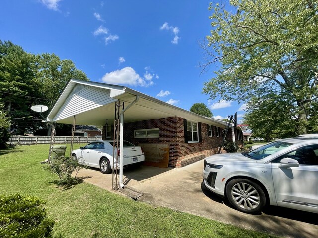 view of side of property featuring a yard and a carport