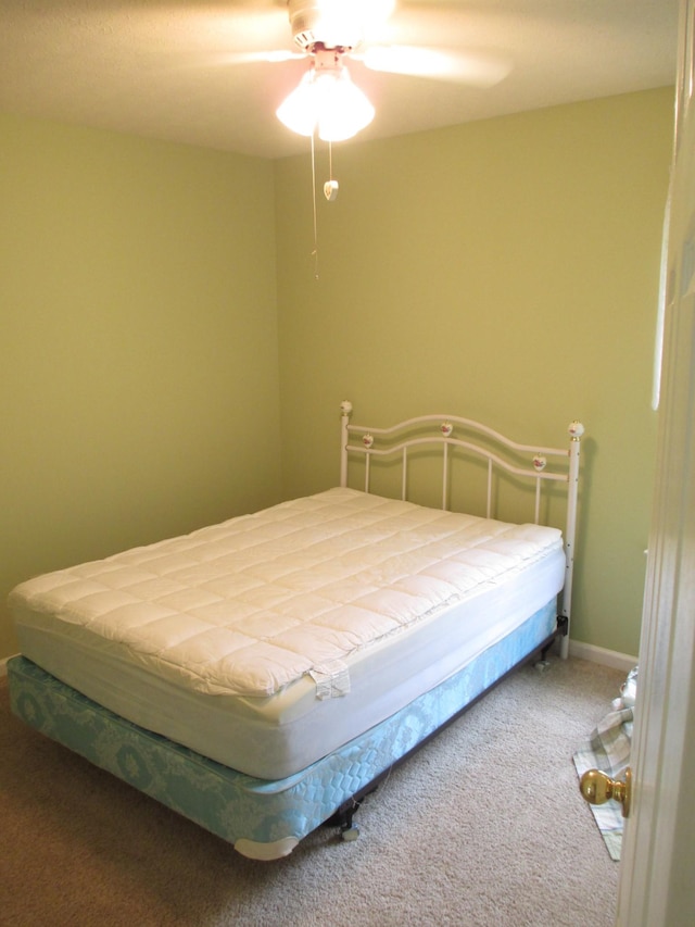 bedroom with ceiling fan and carpet floors